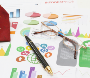 a pen and eyeglasses with an infographics background