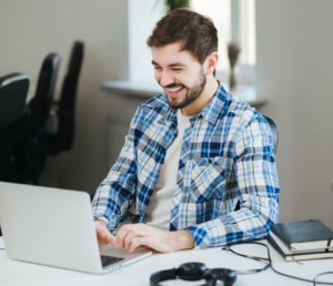 man working on his laptop to create landing pages